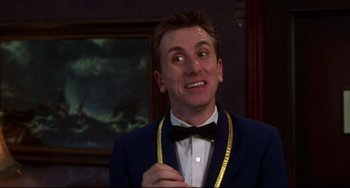 Movie still from “Four Rooms” (1995), directed by Robert Rodriguez – A man wearing a suit and bow tie; Close Up shot, Low angle