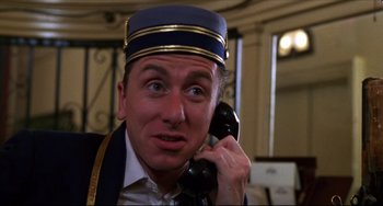 Movie still from “Four Rooms” (1995), directed by Robert Rodriguez – A person talking on a phone; Close Up shot, Low angle