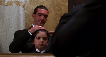 Movie still from “Four Rooms” (1995), directed by Robert Rodriguez – A young boy getting his hair combed by a man; Close Up shot, Low angle