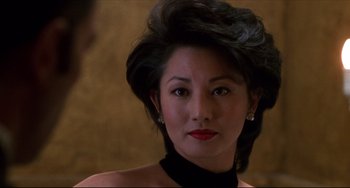 Movie still from “Four Rooms” (1995), directed by Robert Rodriguez – A person wearing a black shirt; Close Up shot, Over the shoulder angle