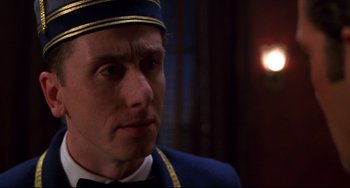 Movie still from “Four Rooms” (1995), directed by Robert Rodriguez – A person wearing a uniform; Close Up shot, Low angle