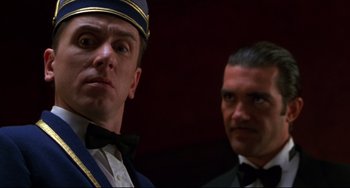 Movie still from “Four Rooms” (1995), directed by Robert Rodriguez – Two men in suits and ties standing next to each other; Close Up shot, Low angle