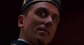 Movie still from “Four Rooms” (1995), directed by Robert Rodriguez – A person wearing a uniform; Close Up shot, Low angle