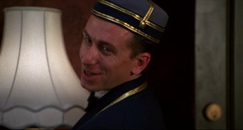 Movie still from “Four Rooms” (1995), directed by Robert Rodriguez – A man wearing a uniform and a hat; Close Up shot, Low angle