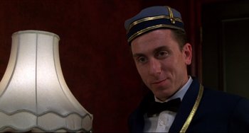 Movie still from “Four Rooms” (1995), directed by Robert Rodriguez – A person wearing a hat; Close Up shot, Low angle