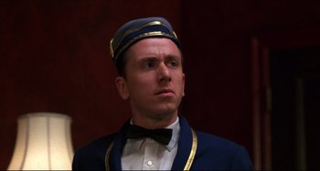 Movie still from “Four Rooms” (1995), directed by Robert Rodriguez – A person wearing a hat; Close Up shot, Low angle