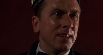 Movie still from “Four Rooms” (1995), directed by Robert Rodriguez – A person wearing a uniform; Close Up shot, Low angle