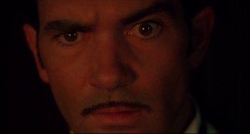 Movie still from “Four Rooms” (1995), directed by Robert Rodriguez – A man's eyes with a dark background; Extreme Close Up shot, High angle