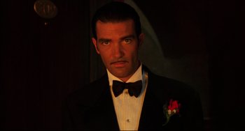 Movie still from “Four Rooms” (1995), directed by Robert Rodriguez – A man in a suit and bow tie; Close Up shot, Low angle
