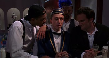 Movie still from “Four Rooms” (1995), directed by Robert Rodriguez – A group of men standing next to each other in a room; Medium shot, Over the shoulder angle