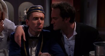 Movie still from “Four Rooms” (1995), directed by Robert Rodriguez – Two men in suits and ties are talking to each other; Close Up shot, Over the shoulder angle