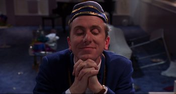 Movie still from “Four Rooms” (1995), directed by Robert Rodriguez – A man with his eyes closed and his hands clasped together; Close Up shot, Low angle