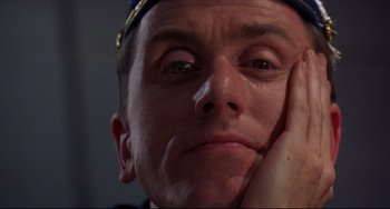 Movie still from “Four Rooms” (1995), directed by Robert Rodriguez – A person with his hand on his face; Close Up shot, Low angle