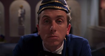 Movie still from “Four Rooms” (1995), directed by Robert Rodriguez – A person wearing a uniform; Close Up shot, Low angle