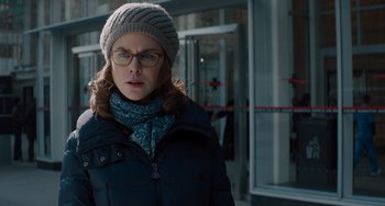 Movie still from “The Upside” (2017), directed by Neil Burger – A woman wearing glasses and a winter hat; Close Up shot, Over the shoulder angle