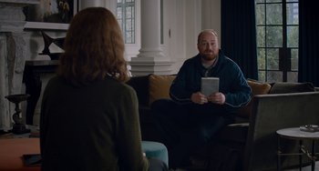 Movie still from “The Upside” (2017), directed by Neil Burger – A man and a woman sitting on a couch; Medium shot, Over the shoulder angle