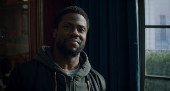 Movie still from “The Upside” (2017), directed by Neil Burger – A person wearing a jacket; Close Up shot, Over the shoulder angle