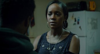 Movie still from “The Upside” (2017), directed by Neil Burger – A woman wearing a necklace is looking at a man; Close Up shot, Over the shoulder angle