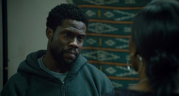 Movie still from “The Upside” (2017), directed by Neil Burger – A man in a green jacket is looking at a woman; Close Up shot, Over the shoulder angle