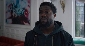 Movie still from “The Upside” (2017), directed by Neil Burger – A person with a beard; Close Up shot, Over the shoulder angle