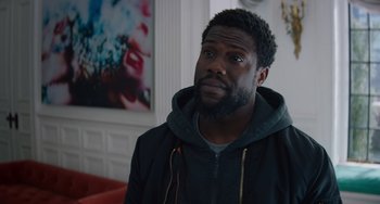 Movie still from “The Upside” (2017), directed by Neil Burger – A person wearing a jacket; Close Up shot, Over the shoulder angle