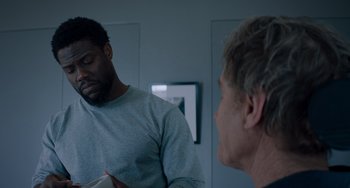 Movie still from “The Upside” (2017), directed by Neil Burger – Two men are talking in a room; Medium shot, Over the shoulder angle