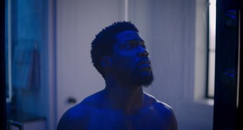 Movie still from “The Upside” (2017), directed by Neil Burger – A man with a beard is looking up at the sky; Close Up shot, Low angle