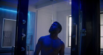 Movie still from “The Upside” (2017), directed by Neil Burger – A man standing in front of a mirror in a bathroom; Medium shot, Low angle