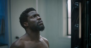 Movie still from “The Upside” (2017), directed by Neil Burger – A person with a beard looking up; Close Up shot, Low angle