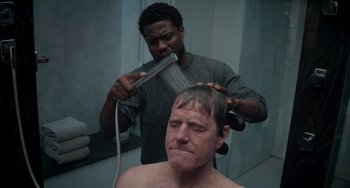 Movie still from “The Upside” (2017), directed by Neil Burger – A man getting his head shaved in a bathroom; Close Up shot, Over the shoulder angle