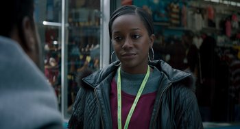 Movie still from “The Upside” (2017), directed by Neil Burger – A woman wearing a black leather jacket and a pink sweater; Close Up shot, Over the shoulder angle