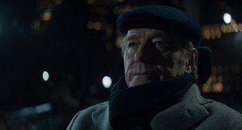 Movie still from “The Upside” (2017), directed by Neil Burger – An older man wearing a hat and a scarf; Close Up shot, Over the shoulder angle