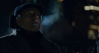 Movie still from “The Upside” (2017), directed by Neil Burger – An older man wearing a hat and a coat; Close Up shot, Low angle