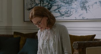 Movie still from “The Upside” (2017), directed by Neil Burger – A woman in a white shirt and a white sweater; Medium shot, Over the shoulder angle