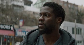 Movie still from “The Upside” (2017), directed by Neil Burger – A person with a beard; Close Up shot, Over the shoulder angle