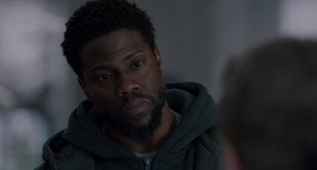 Movie still from “The Upside” (2017), directed by Neil Burger – A person with a beard; Close Up shot, Over the shoulder angle