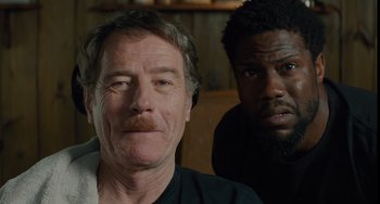 Movie still from “The Upside” (2017), directed by Neil Burger – A man and a black man are posing for a picture; Close Up shot, Over the shoulder angle