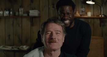 Movie still from “The Upside” (2017), directed by Neil Burger – Two men are smiling for the camera; Close Up shot, Over the shoulder angle
