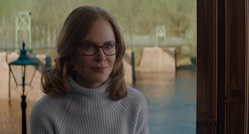 Movie still from “The Upside” (2017), directed by Neil Burger – A person wearing glasses and a sweater; Close Up shot, Over the shoulder angle