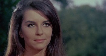 Movie still from “Four Times That Night” (1971), directed by Mario Bava – A woman's face with a forest in the background; Close Up shot, Low angle