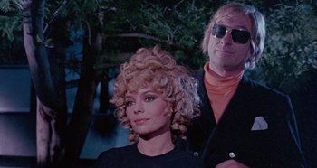 Movie still from “Four Times That Night” (1971), directed by Mario Bava – A man and a woman are standing next to each other; Close Up shot, Low angle