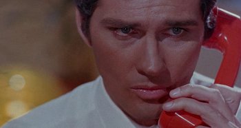 Movie still from “Four Times That Night” (1971), directed by Mario Bava – A person talking on a phone; Extreme Close Up shot, Low angle