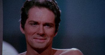 Movie still from “Four Times That Night” (1971), directed by Mario Bava – A man's chest and chest hair; Close Up shot, Over the shoulder angle