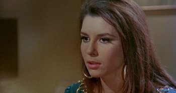 Movie still from “Four Times That Night” (1971), directed by Mario Bava – A person wearing a green shirt; Close Up shot, High angle