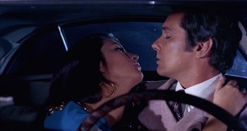 Movie still from “Four Times That Night” (1971), directed by Mario Bava – A man and a woman in the back seat of a car; Close Up shot, Low angle