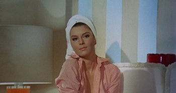 Movie still from “Four Times That Night” (1971), directed by Mario Bava – A woman with a towel wrapped around her head; Close Up shot, Low angle