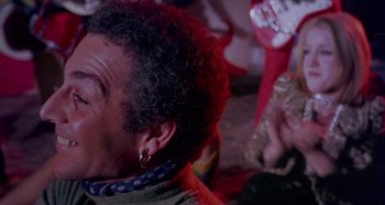 Movie still from “Four Times That Night” (1971), directed by Mario Bava – A person wearing a jacket and ear rings; Close Up shot, Low angle