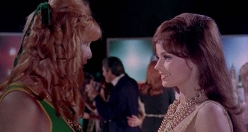 Movie still from “Four Times That Night” (1971), directed by Mario Bava – Two women talking to each other at a party; Close Up shot, Over the shoulder angle