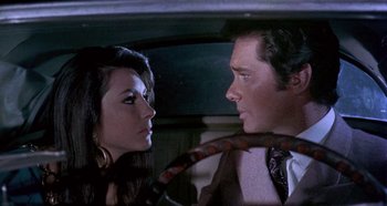 Movie still from “Four Times That Night” (1971), directed by Mario Bava – A man and a woman in the back of a car; Close Up shot, Over the shoulder angle
