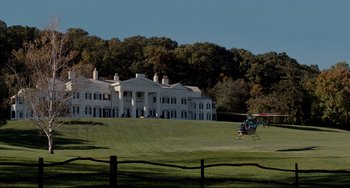 Movie still from “Foxcatcher” (2014), directed by Bennett Miller – A helicopter is flying near a large white house; Extreme Wide shot, Low angle